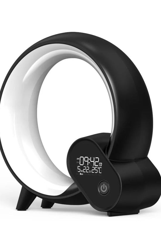 Black modern sunrise alarm clock with digital display and Bluetooth speaker in circular design