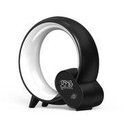 Black modern sunrise alarm clock with digital display and Bluetooth speaker in circular design