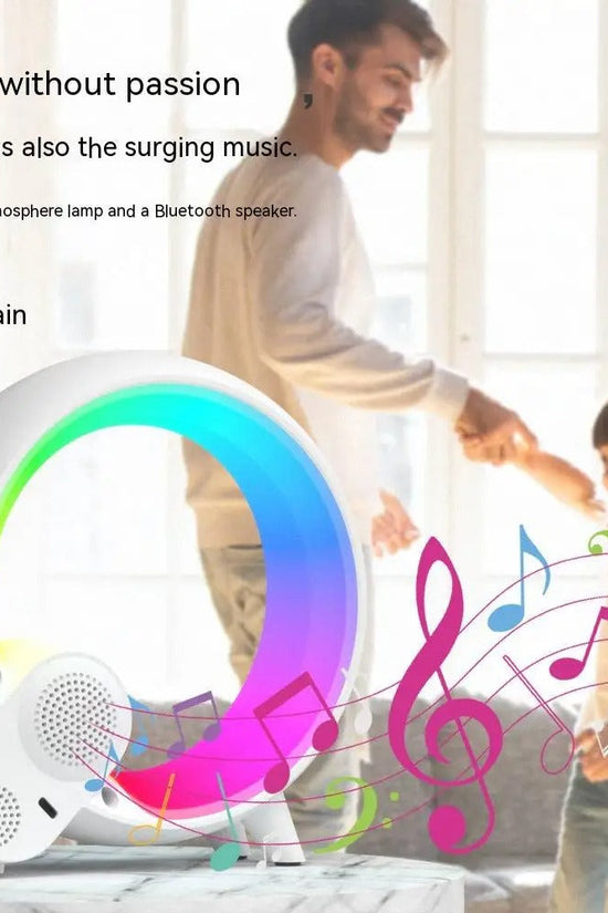 Sunrise alarm clock with Bluetooth speaker and colorful mood lighting playing music in a bright room with a father and child dancing