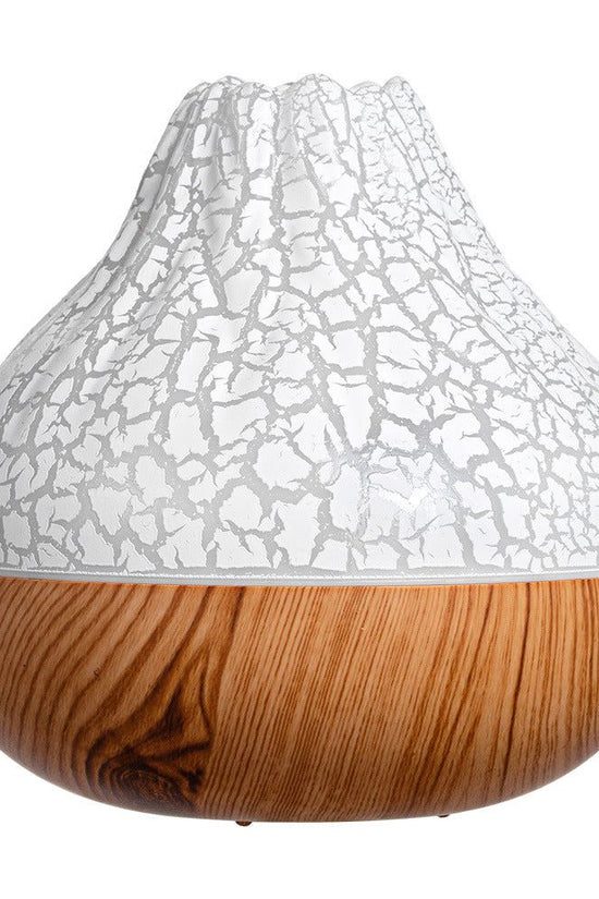 Volcano humidifier with cracked white top and wood grain base for cool mist and ambient light therapy