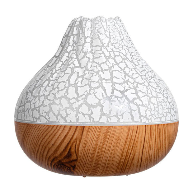 Volcano humidifier with cracked white top and wood grain base for cool mist and ambient light therapy