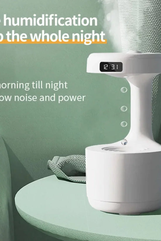White humidifier on a green surface with text highlighting its features