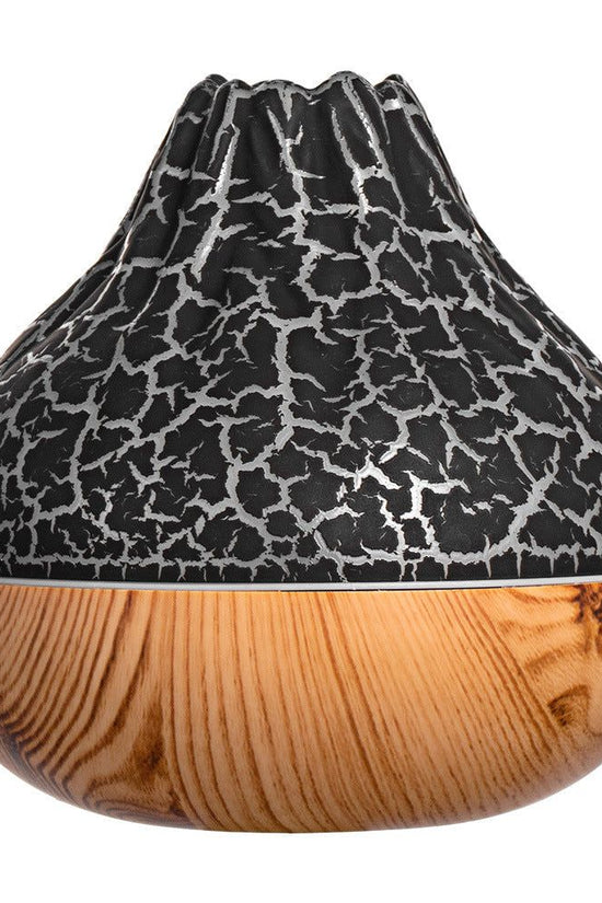 Volcano-shaped humidifier with black cracked top and wood grain base for cool mist and ambient lighting