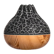 Volcano-shaped humidifier with black cracked top and wood grain base for cool mist and ambient lighting