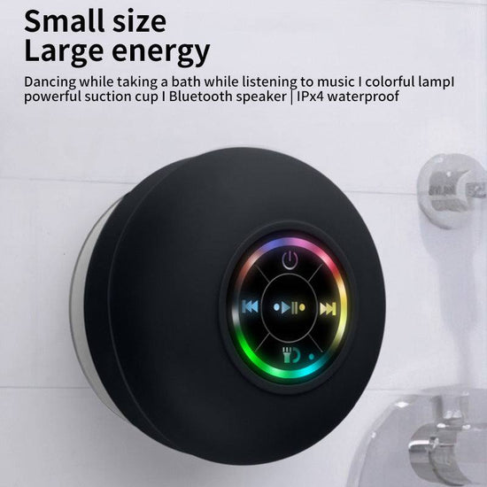 Compact waterproof Bluetooth shower speaker with suction cup and LED mood light attached to bathroom wall