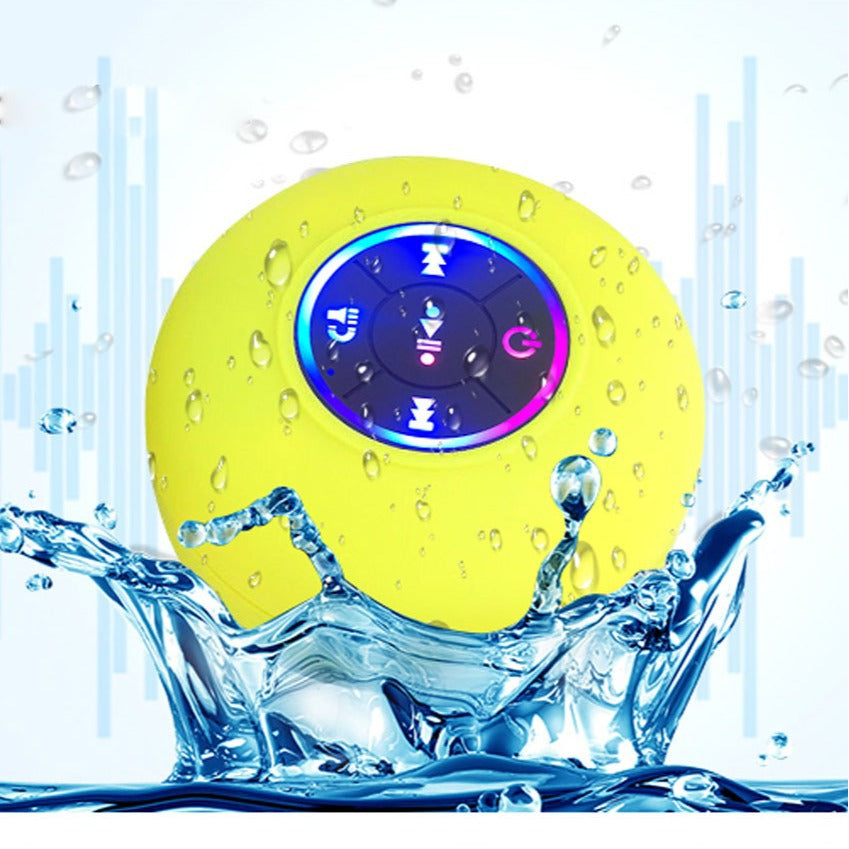Waterproof yellow Bluetooth shower speaker with LED lights and suction cup in water splash